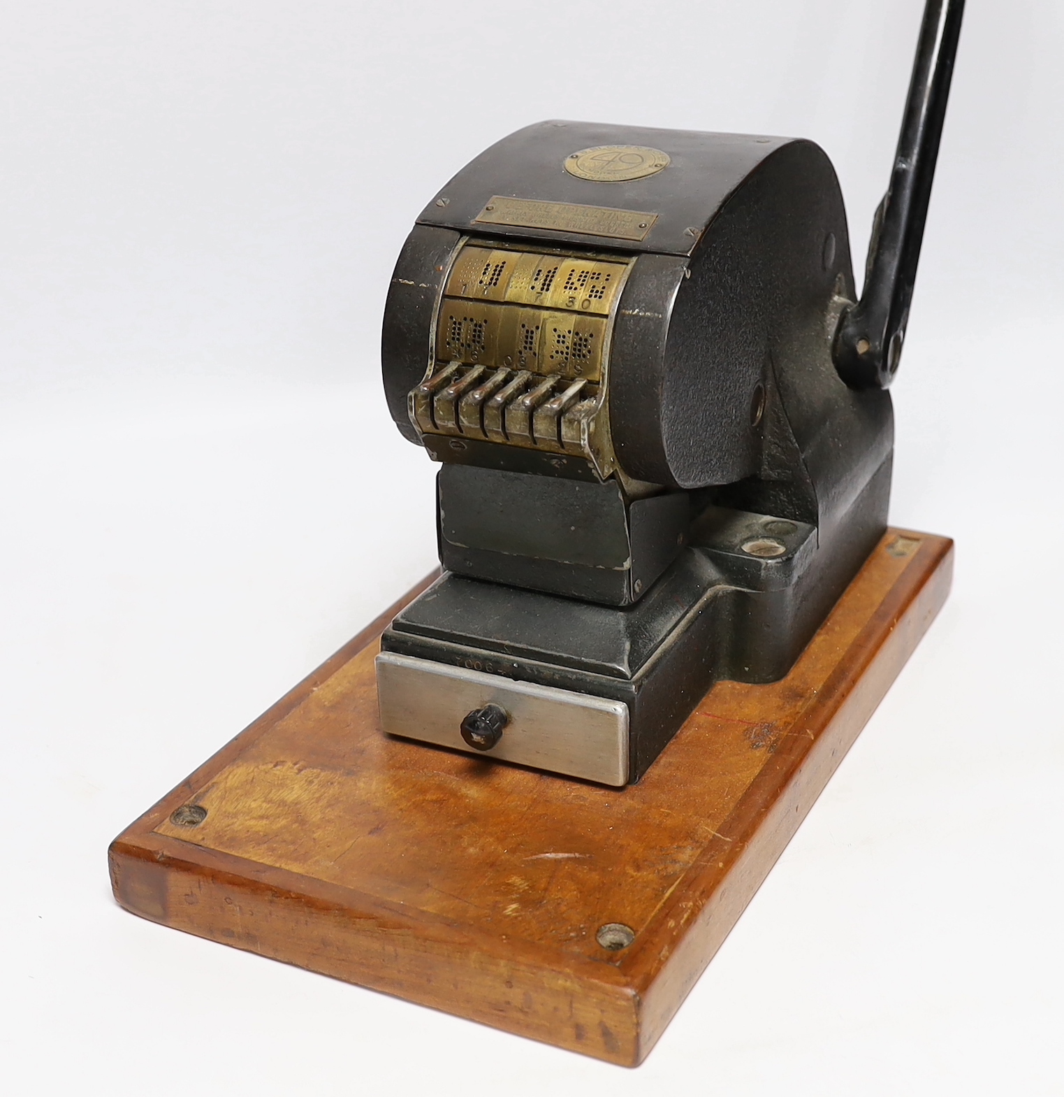 Two stamp perforators, a large example with adjustable date wheels and a smaller which stamps ‘& Co Not Negotiable’